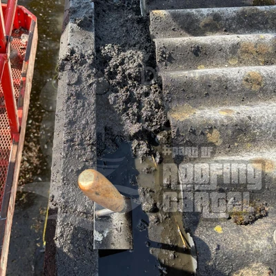 Blocked guttering on asbestos roof