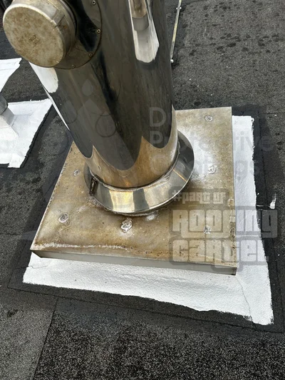 Chimney flashing repair on asbestos roof eliminating leak points around chimney penetration with professional waterproofing