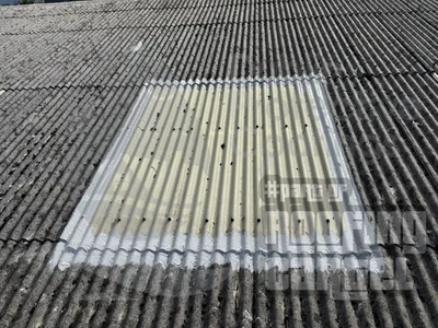 Rooflight seal repair on asbestos roof in Ireland with precision waterproofing treatment around skylight frame