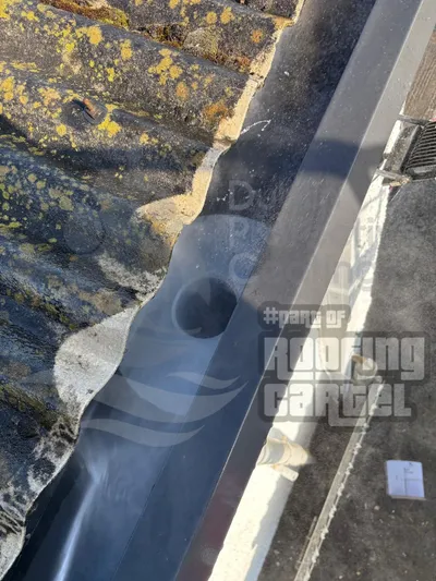 Valley repair on asbestos roof with reinforced waterproof coating